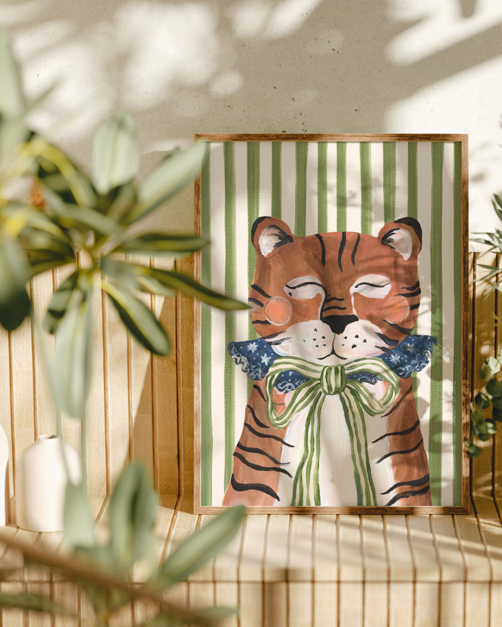 Framed artwork of a tiger with a bow tie on a striped background