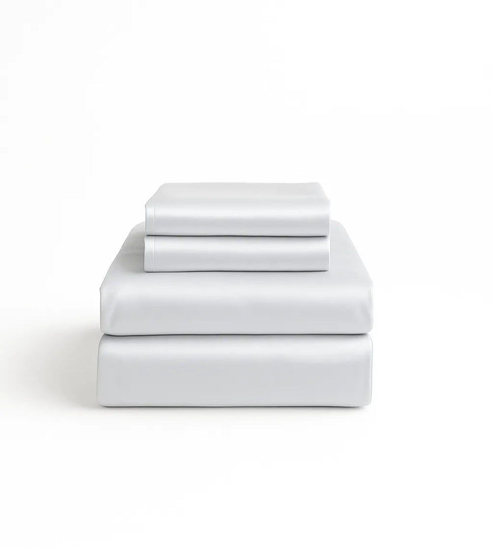 Set of white bed sheets stacked on a white background