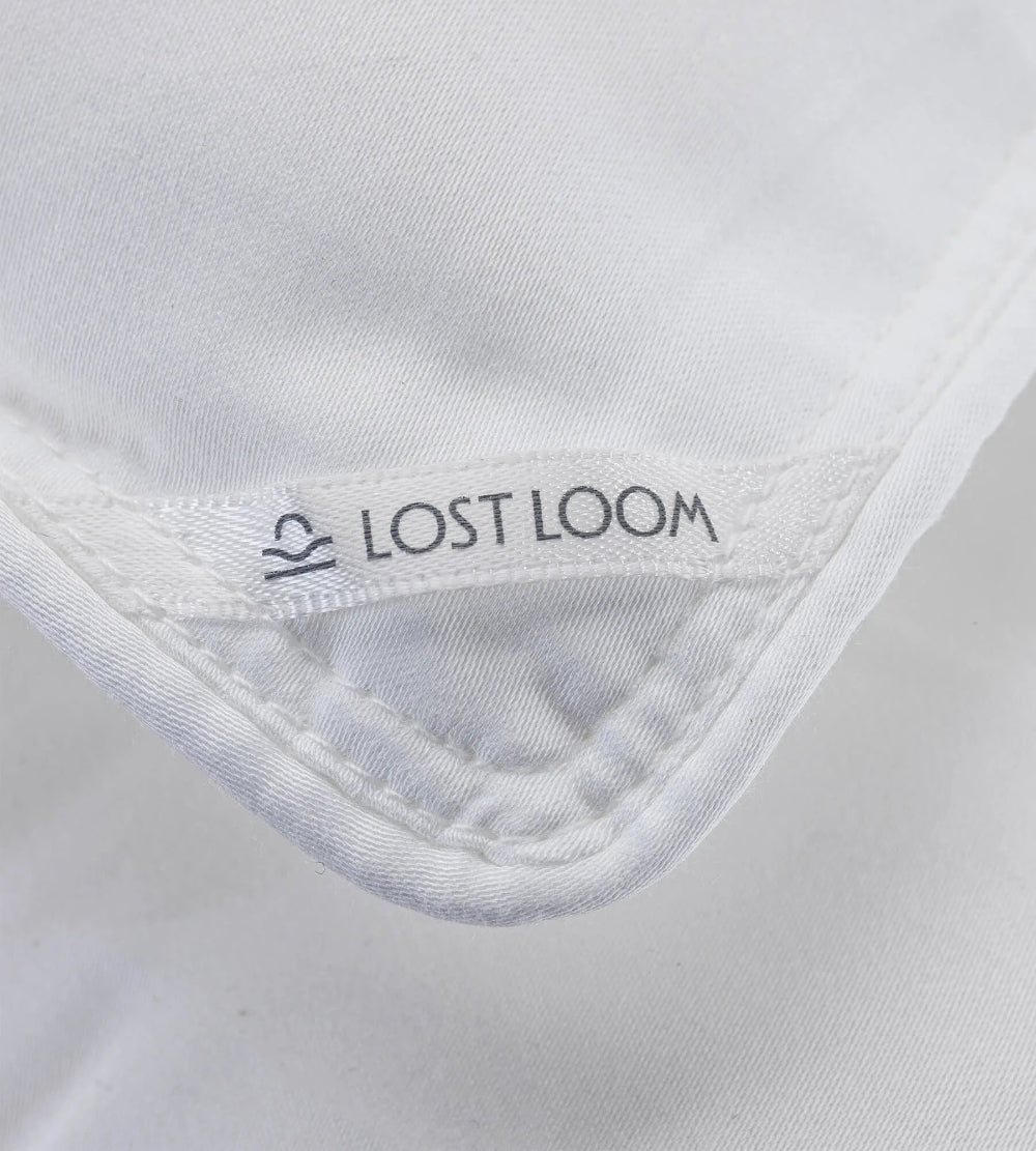 Close-up of a duvet edge with 'Lost Loom' branding.