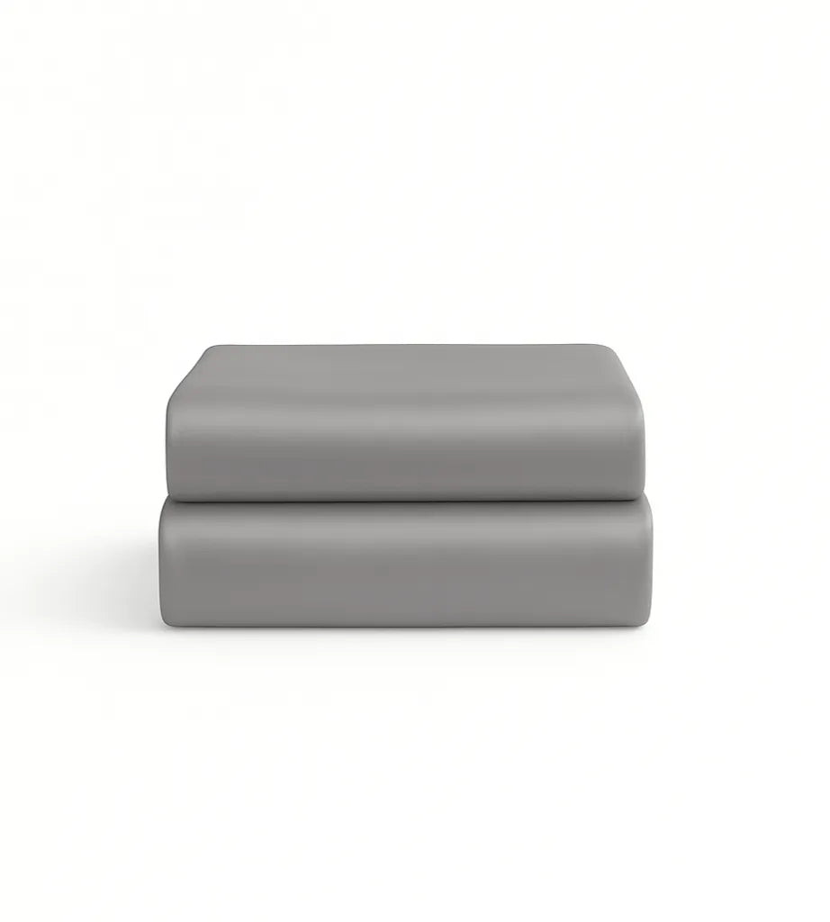 Two grey folded pillowcases on a white background