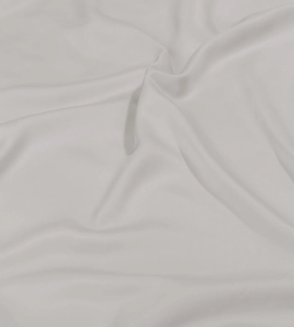 Close-up of grey bedding with folds