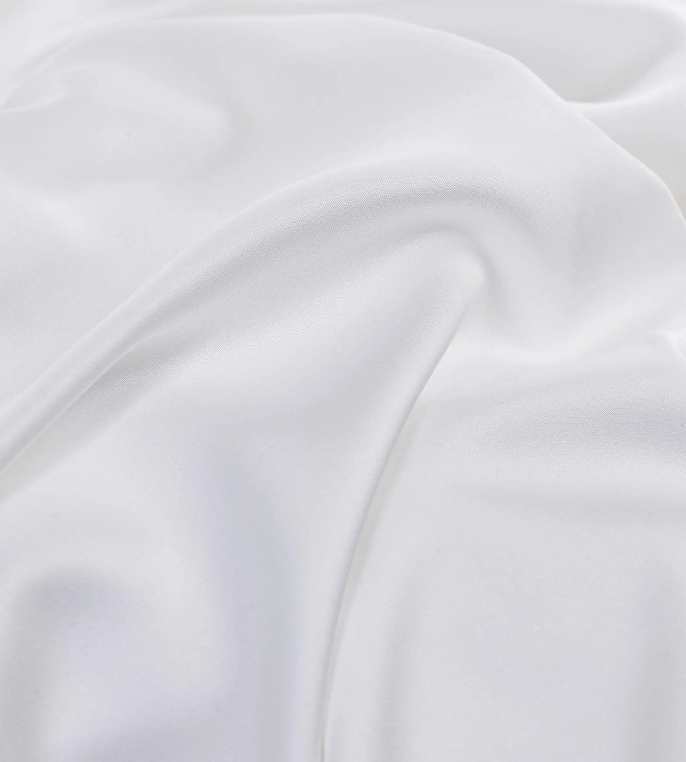 Close-up of white bedding set with subtle texture