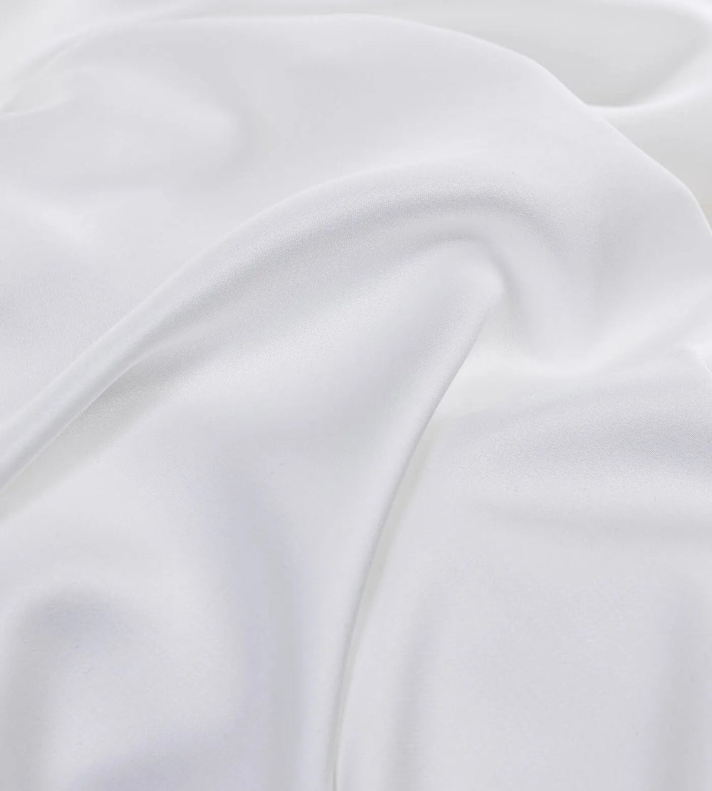 Close-up of white bamboo pillowcases with folds