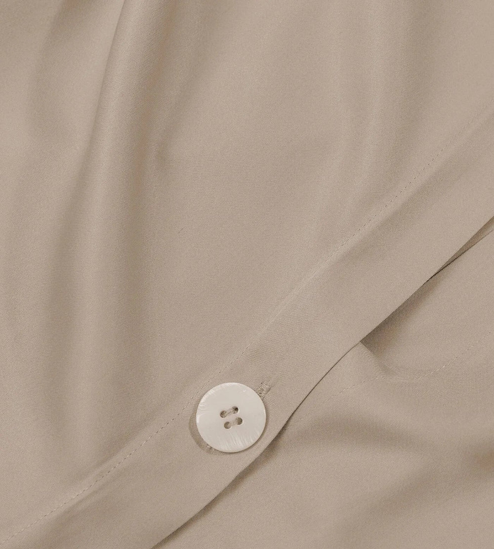 Close-up of Oatmeal duvet set and button