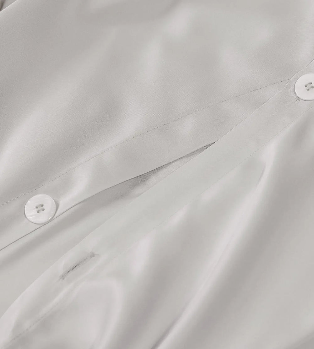 Close-up of a light grey fabric with buttons