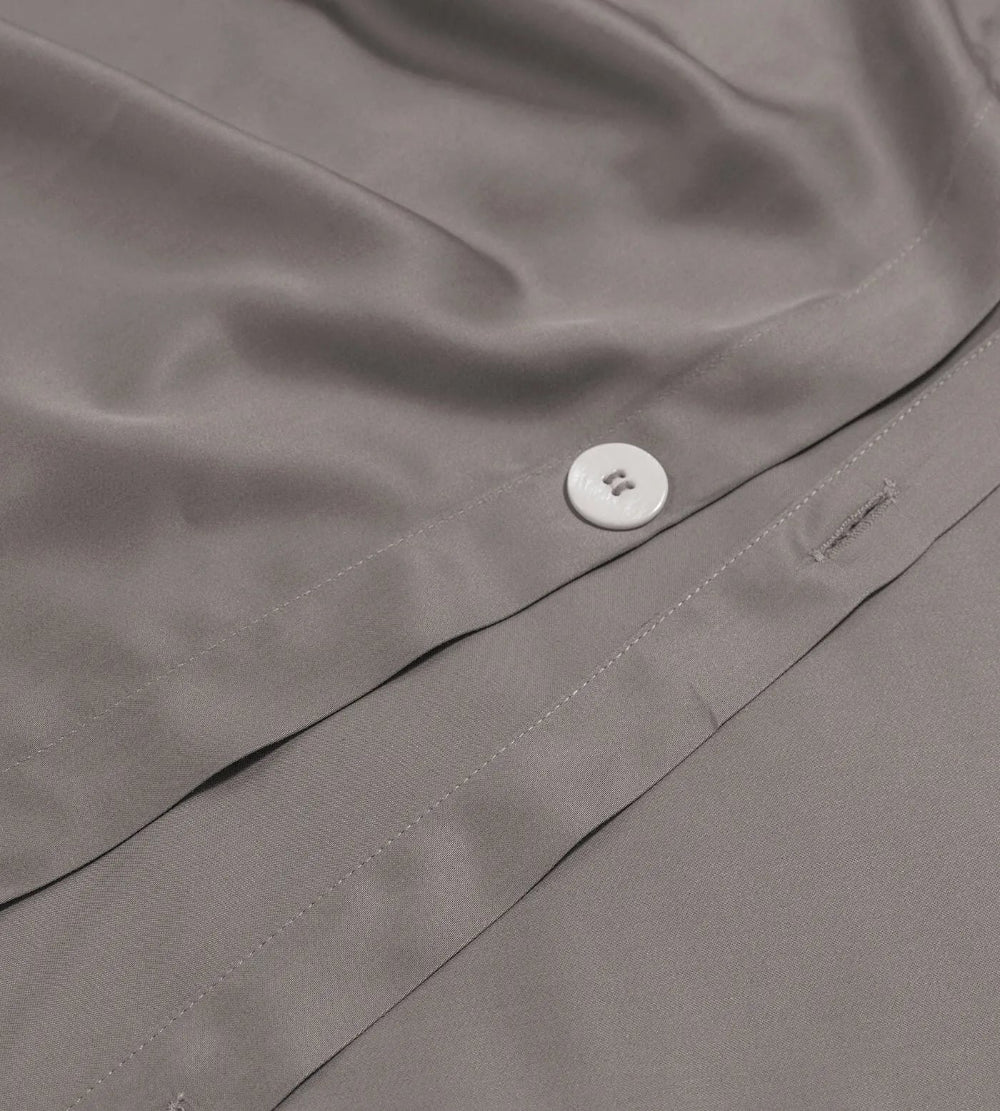 Close-up of a button on a grey duvet set