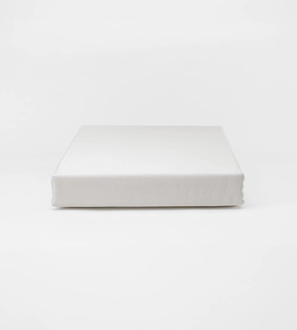 White rectangular cushion on a light grey background