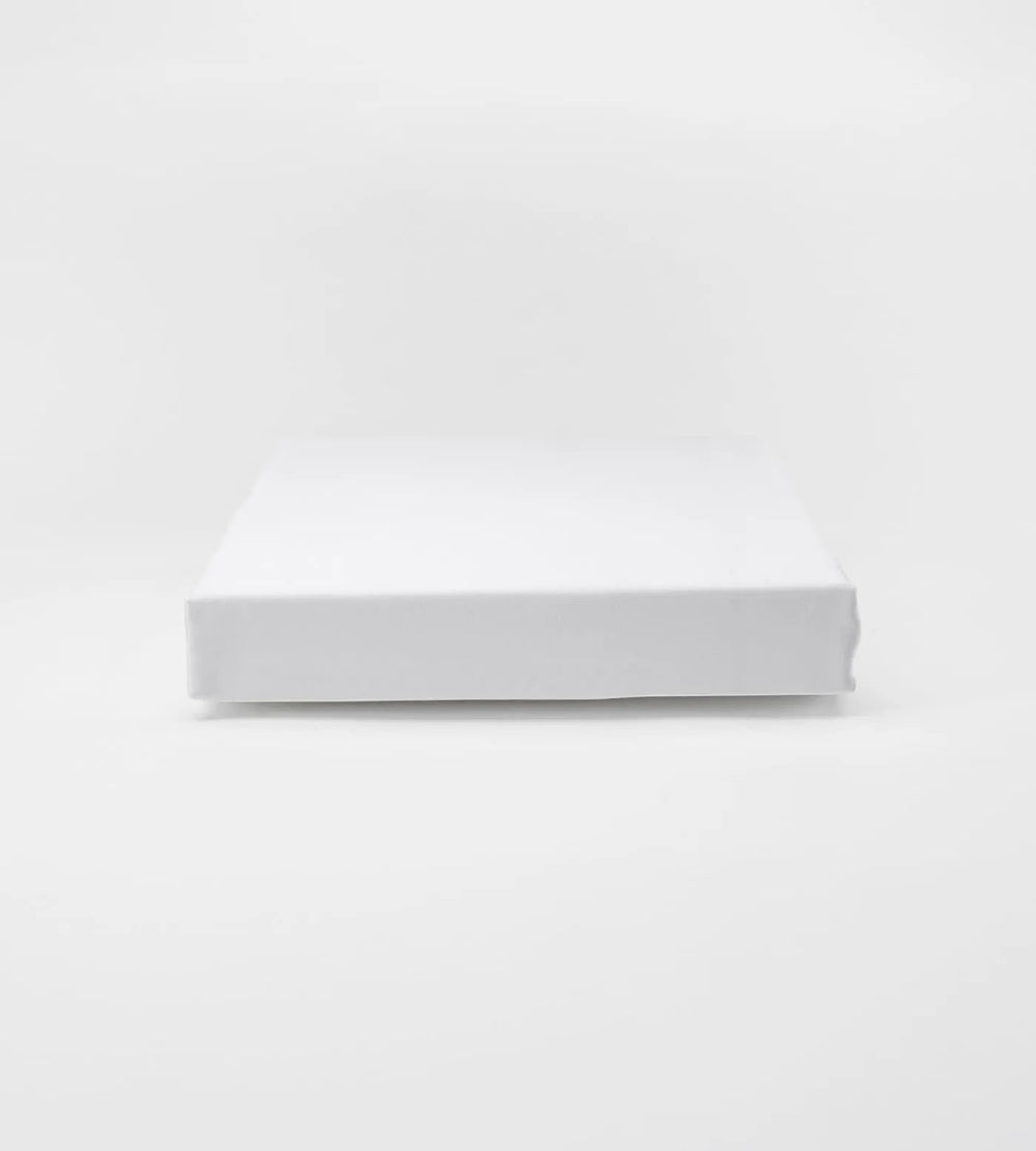 White fitted sheet on a light grey background