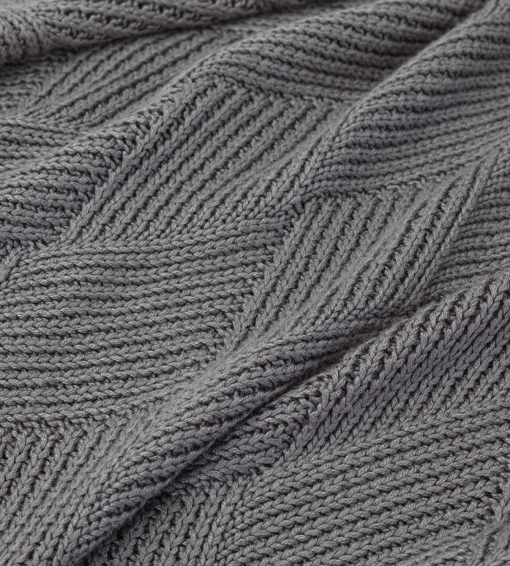 Close-up of a textured grey fabric with a subtle pattern