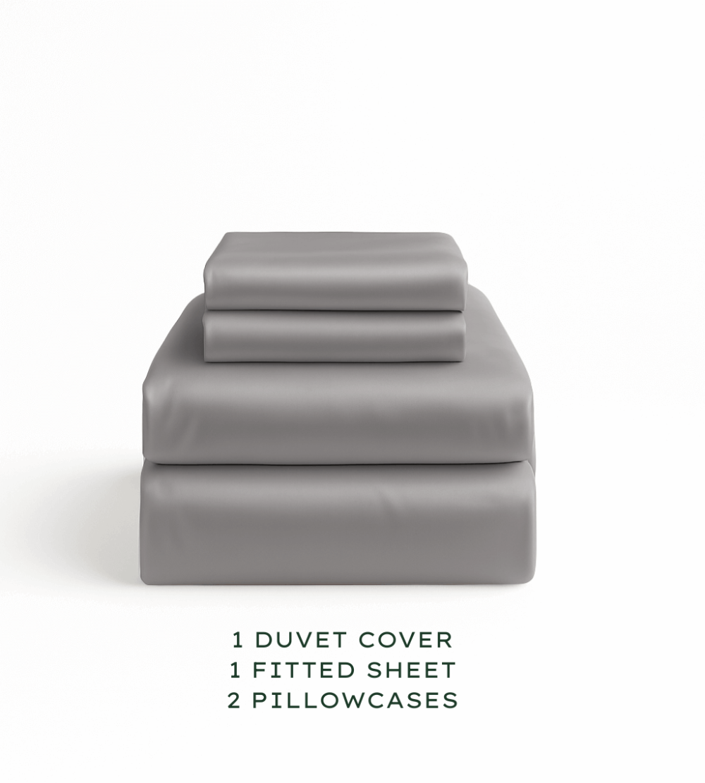 Grey bedding set with duvet cover, fitted sheet, and pillowcases on a white background.