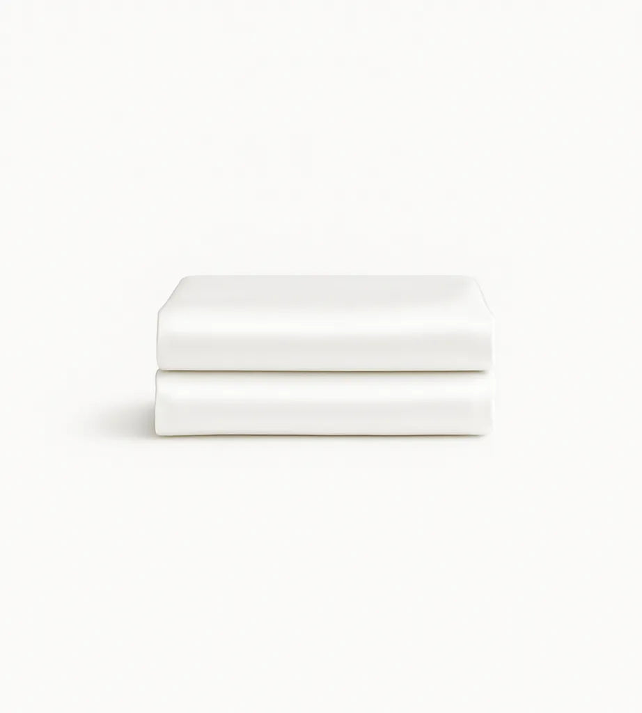 Two white folded bamboo pillowcases on a light beige background