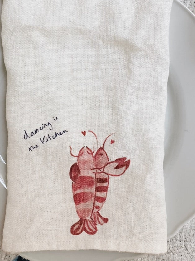 Kitchen towel with lobster design and text on a white background