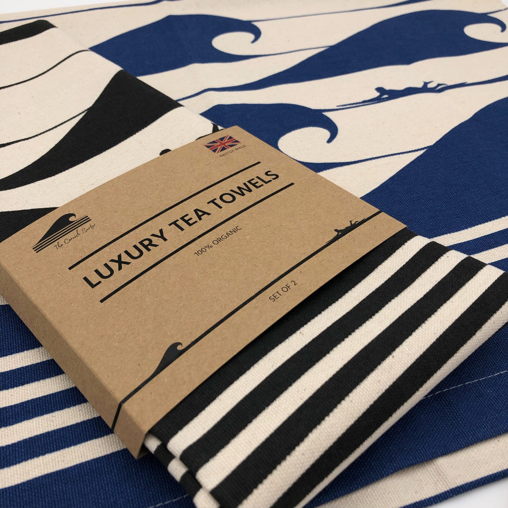 Luxury tea towels with a striped design on a blue and white wave patterned tea towel The Cornish Surfer