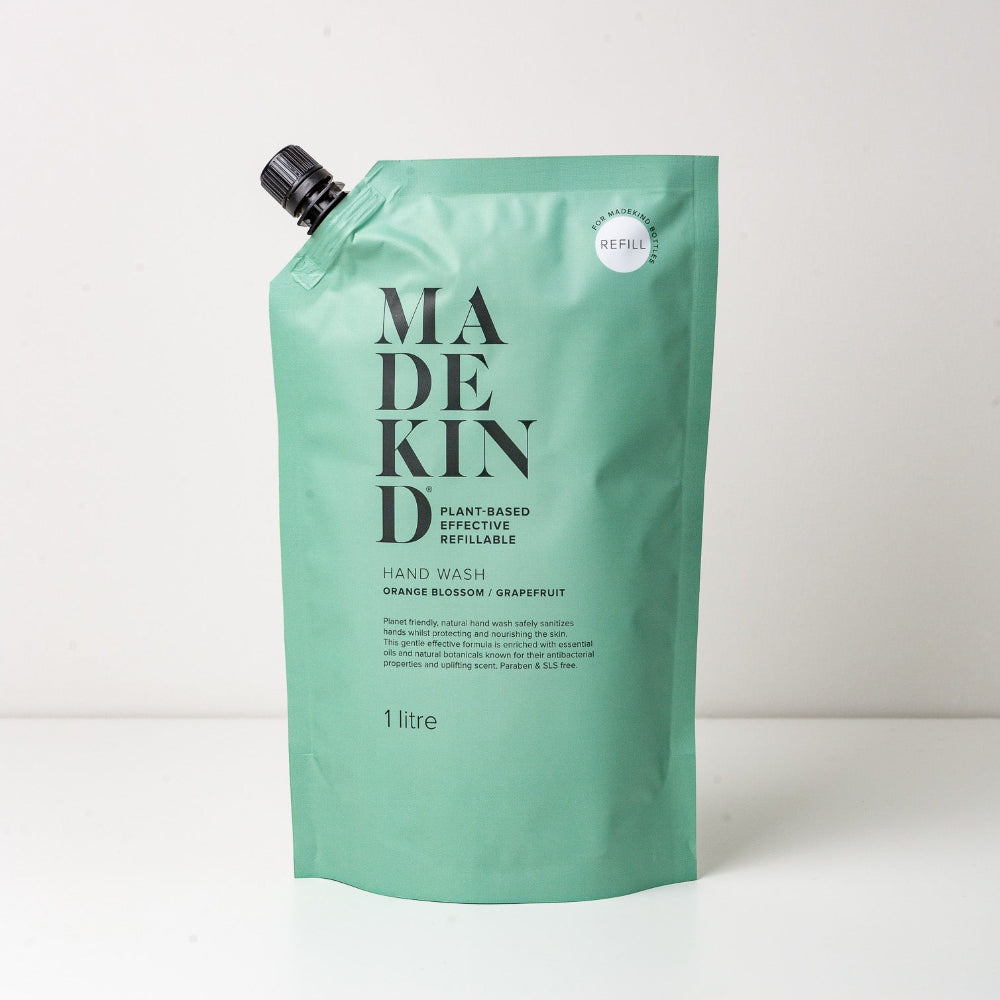Green refillable hand wash packaging with 'MADEKIND' branding on a white background