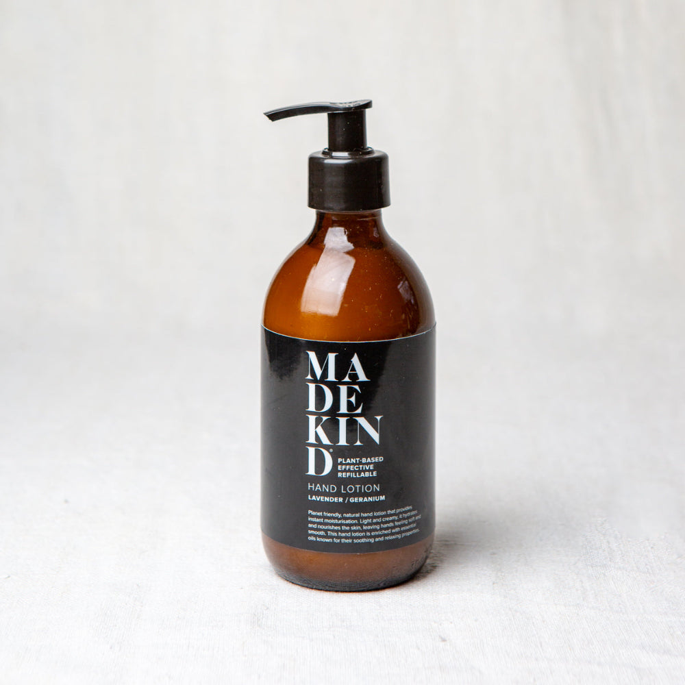 Brown bottle of Lavender and Geranium Hand Lotion with black pump and Madekind label on a white background