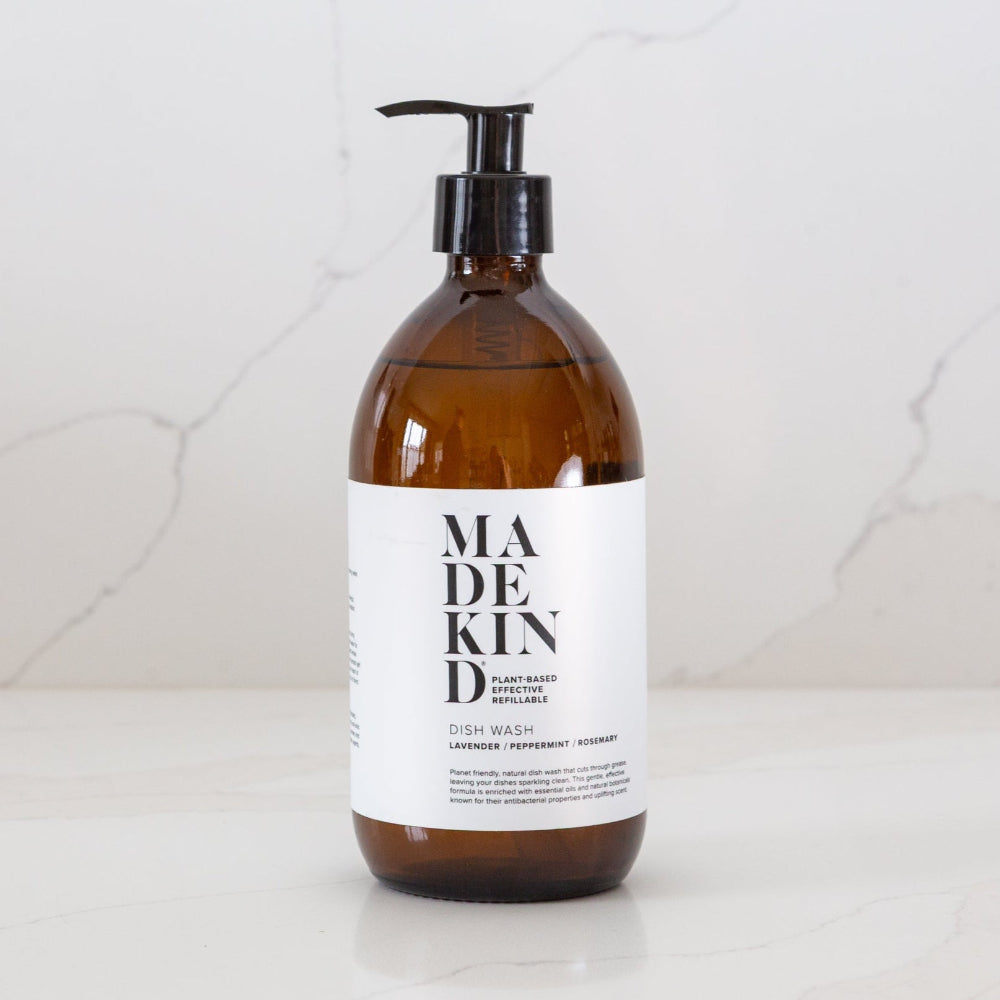 Brown bottle of MadeKind dish wash Lavender peppermint and rosemary with pump on a white background