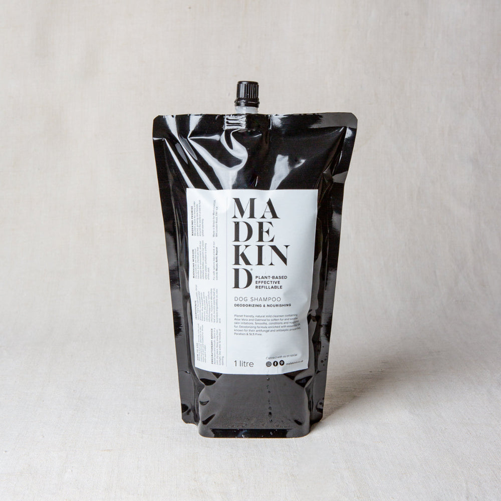 Black refill pouch 1 litre with a label for 'Made Kind' dog shampoo on a light grey background