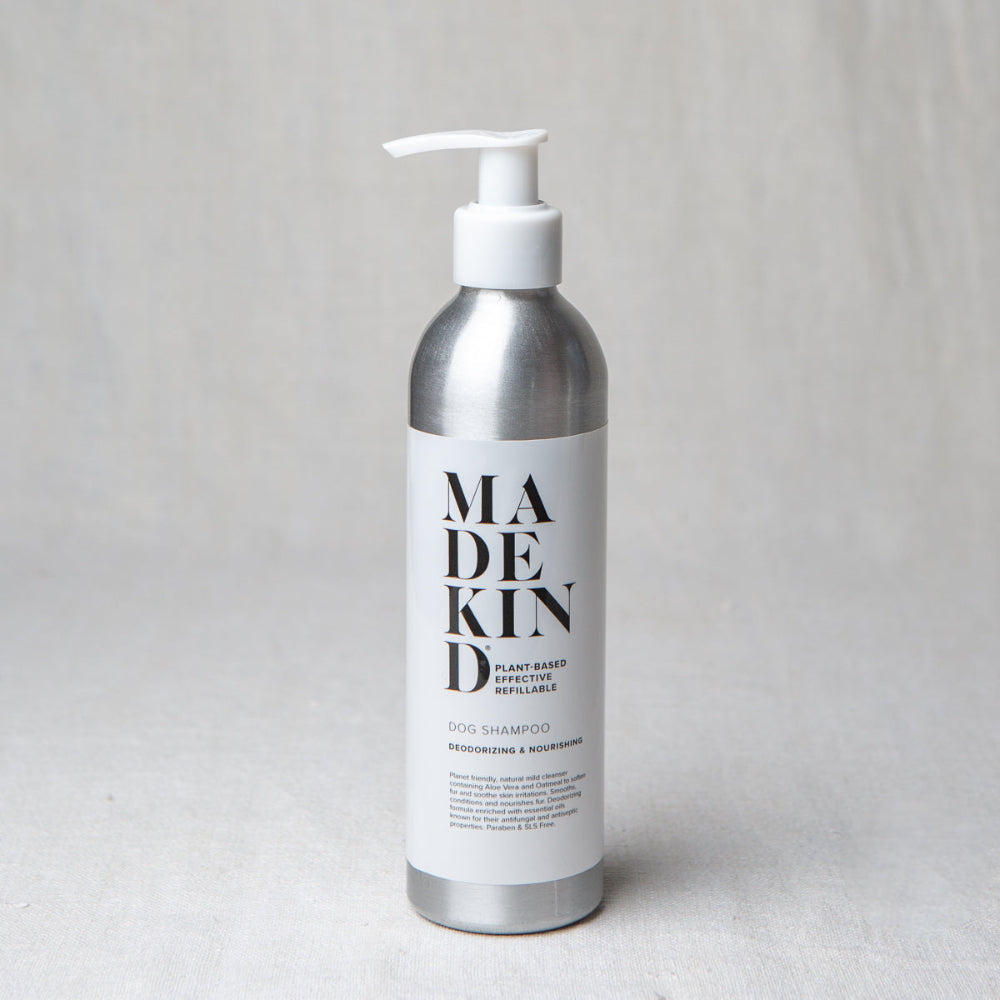 Dog shampoo Silver bottle with pump labelled 'MADEKIND' on a light grey background