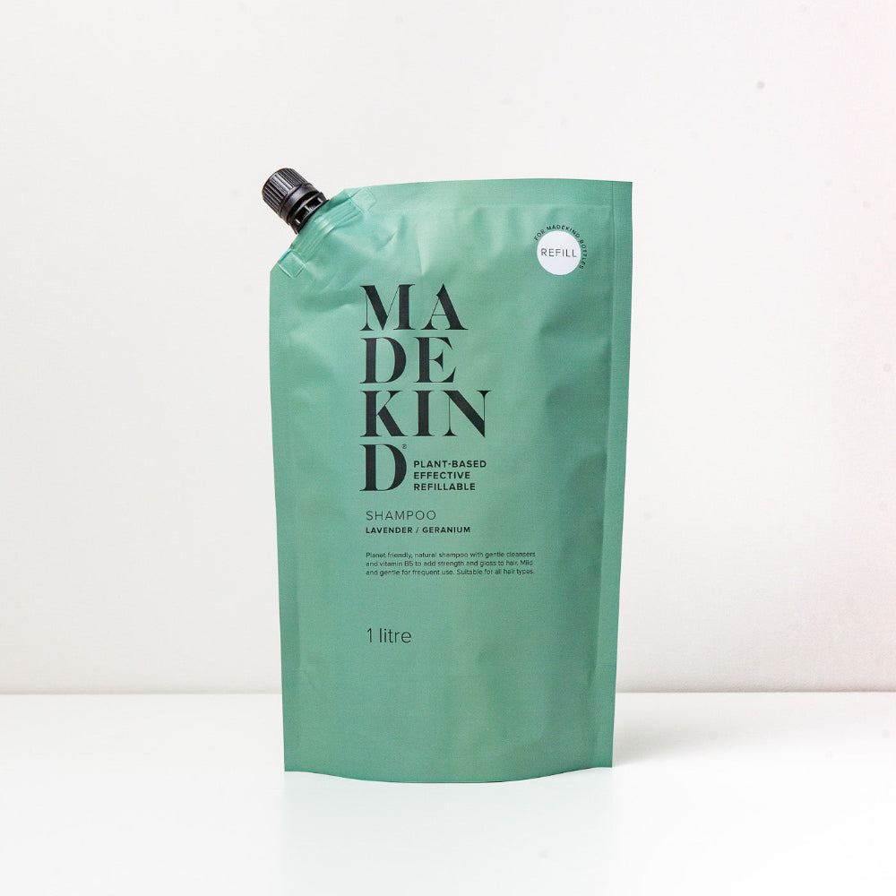 Green refillable shampoo pouch with 'MADEKIND' branding on a white background