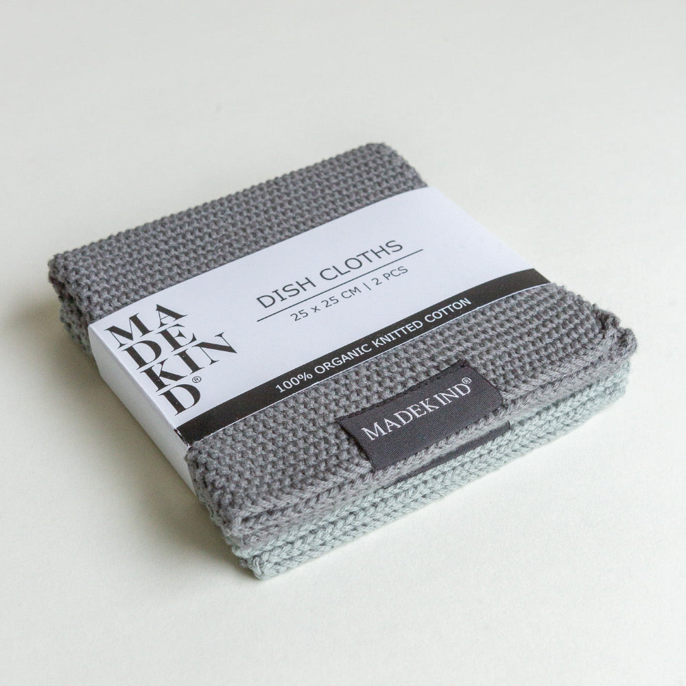 Packaged dish cloths with 'MADEKIND' branding on a light background