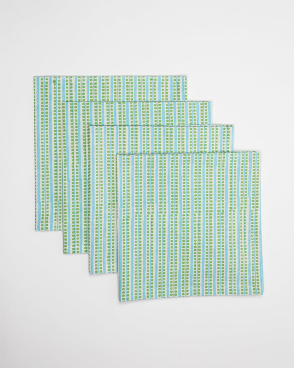 Set of three green and blue patterned placemats on a white background