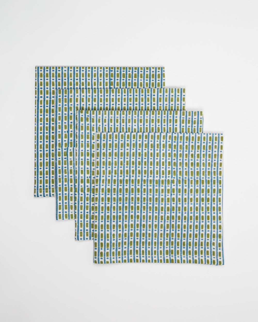 Set of four green and white checkered placemats on a light grey background