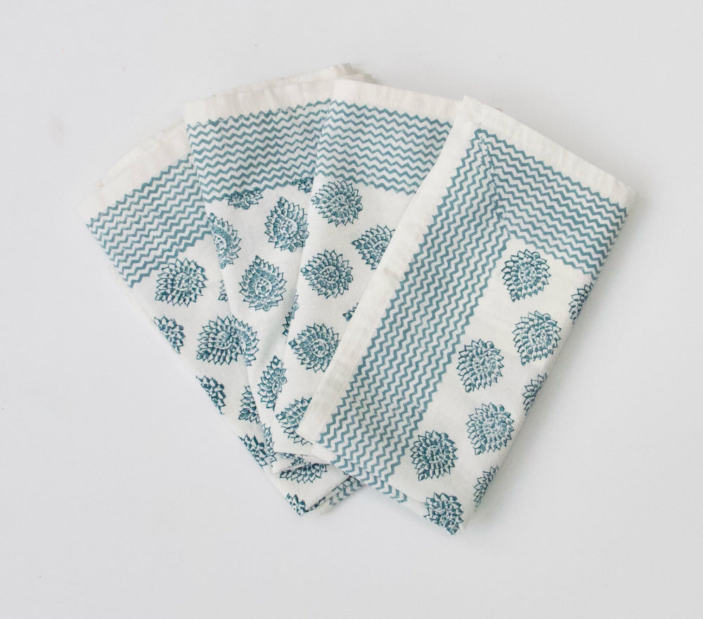 Set of four patterned napkins on a light grey background