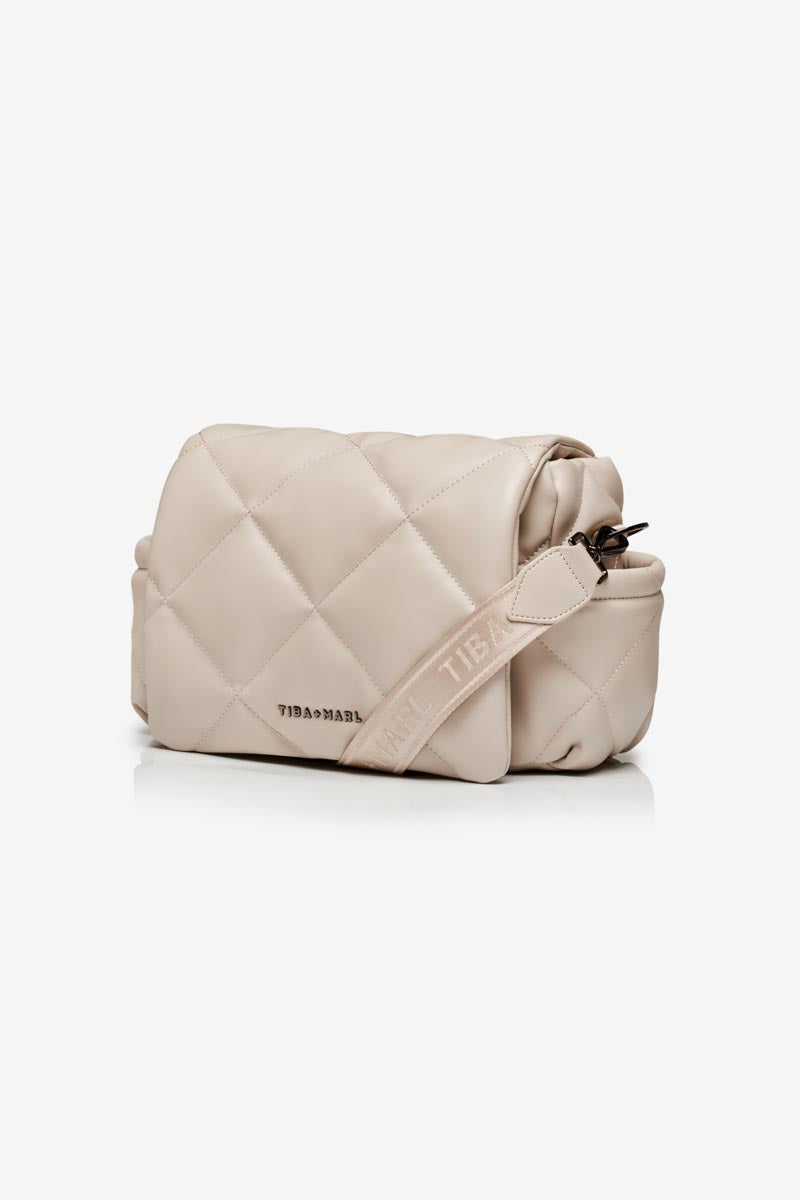 Oyster Couloured quilted handbag with brand logo on a white background