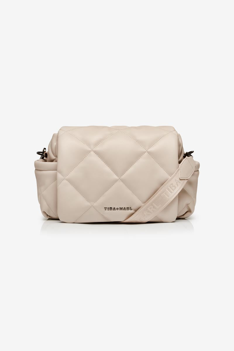 Beige quilted handbag with a visible brand logo Tiba + Marl on a white background