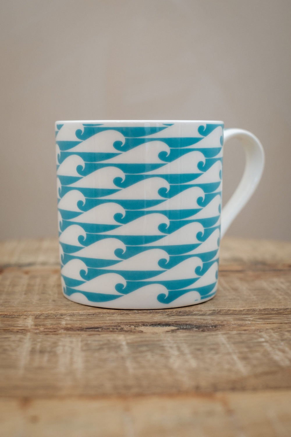 Ocean Jade coloured wave mug on a wooden table