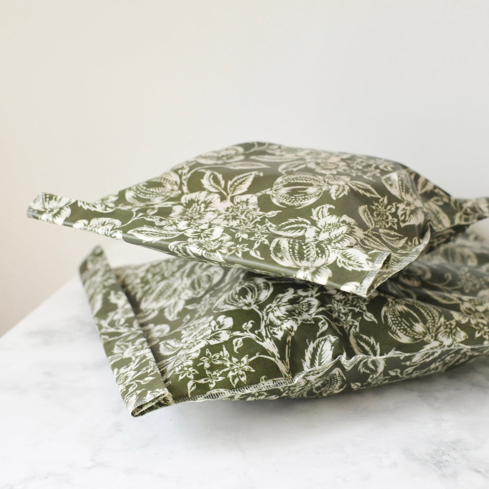 Green floral-patterned food storage bags on a white surface