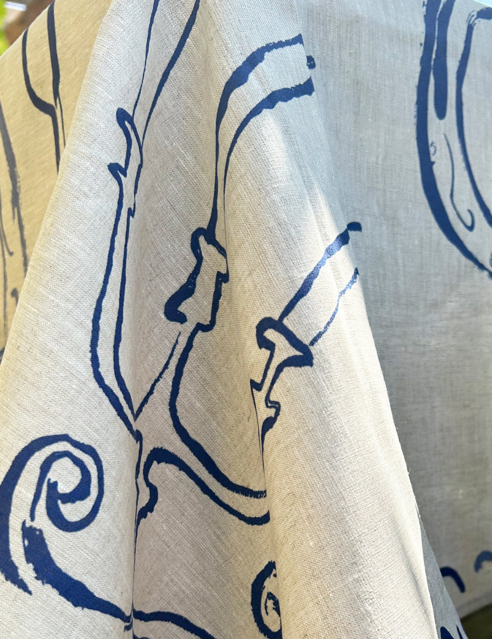 Close-up of fabric with blue floral pattern on beige background