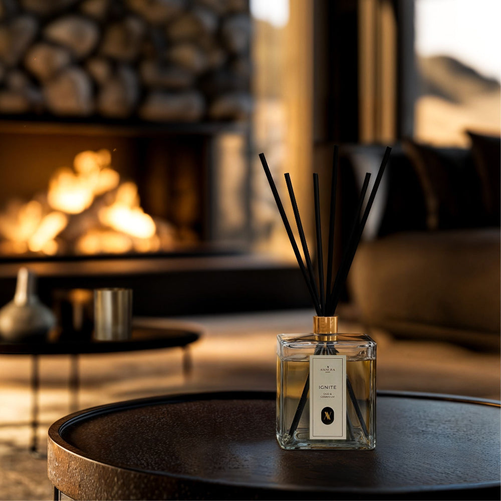 Reed diffuser on a table with a fireplace in the background