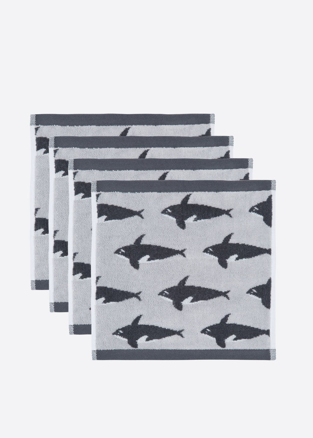 Set of four facecloths with black orca whale pattern on a white background