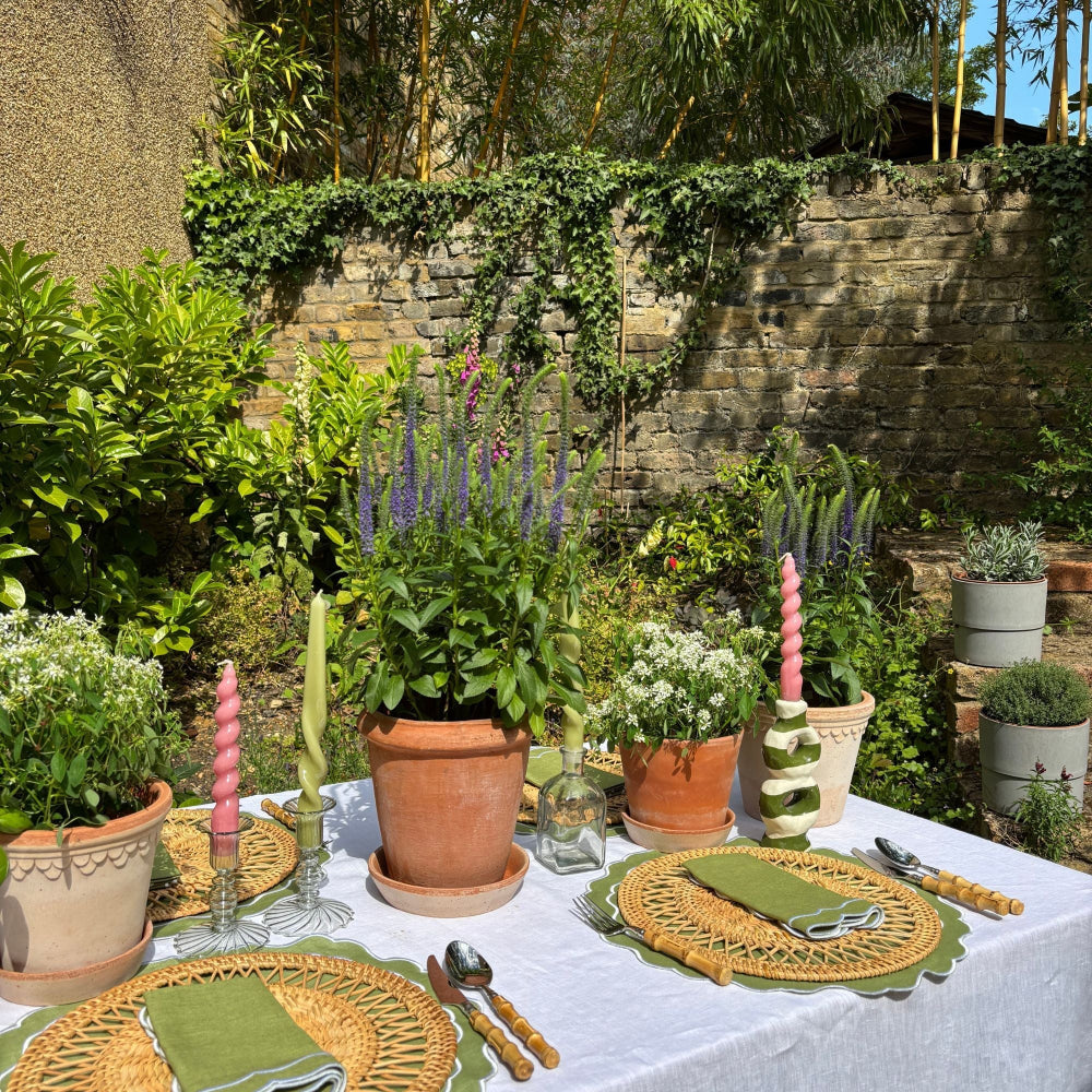 Outdoor table setting with plants and garden decor