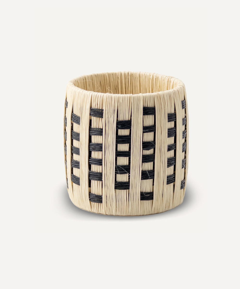 Natural napkin ring with natural black weaving on a white background