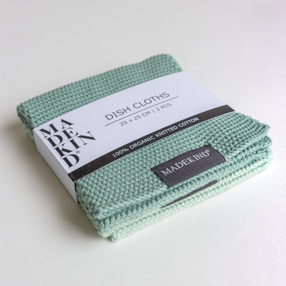 Pack of green dish cloths with 'MADEKIND' branding on a white background
