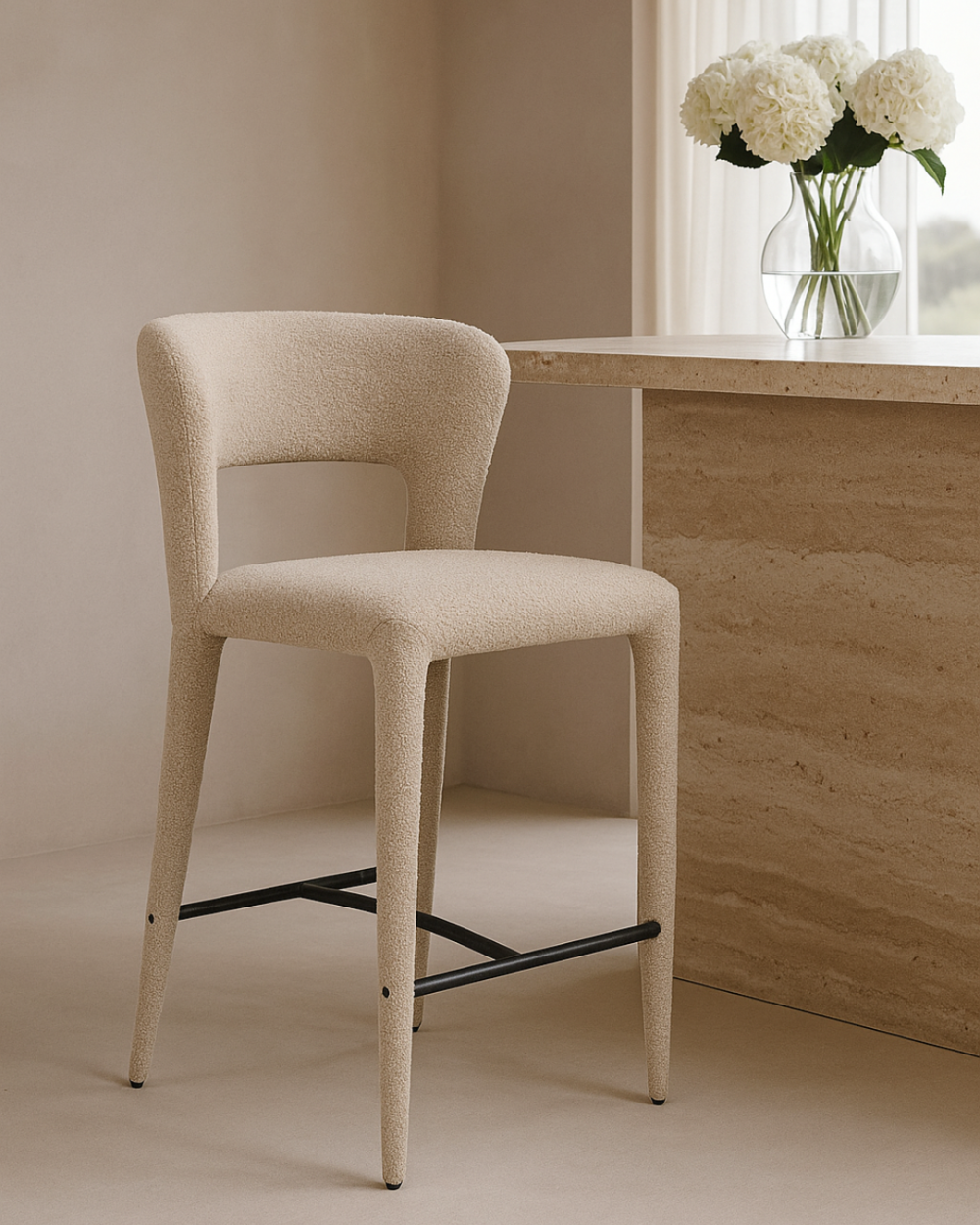 Pari Beige bar stool in a room with a marble desk and white flowers.