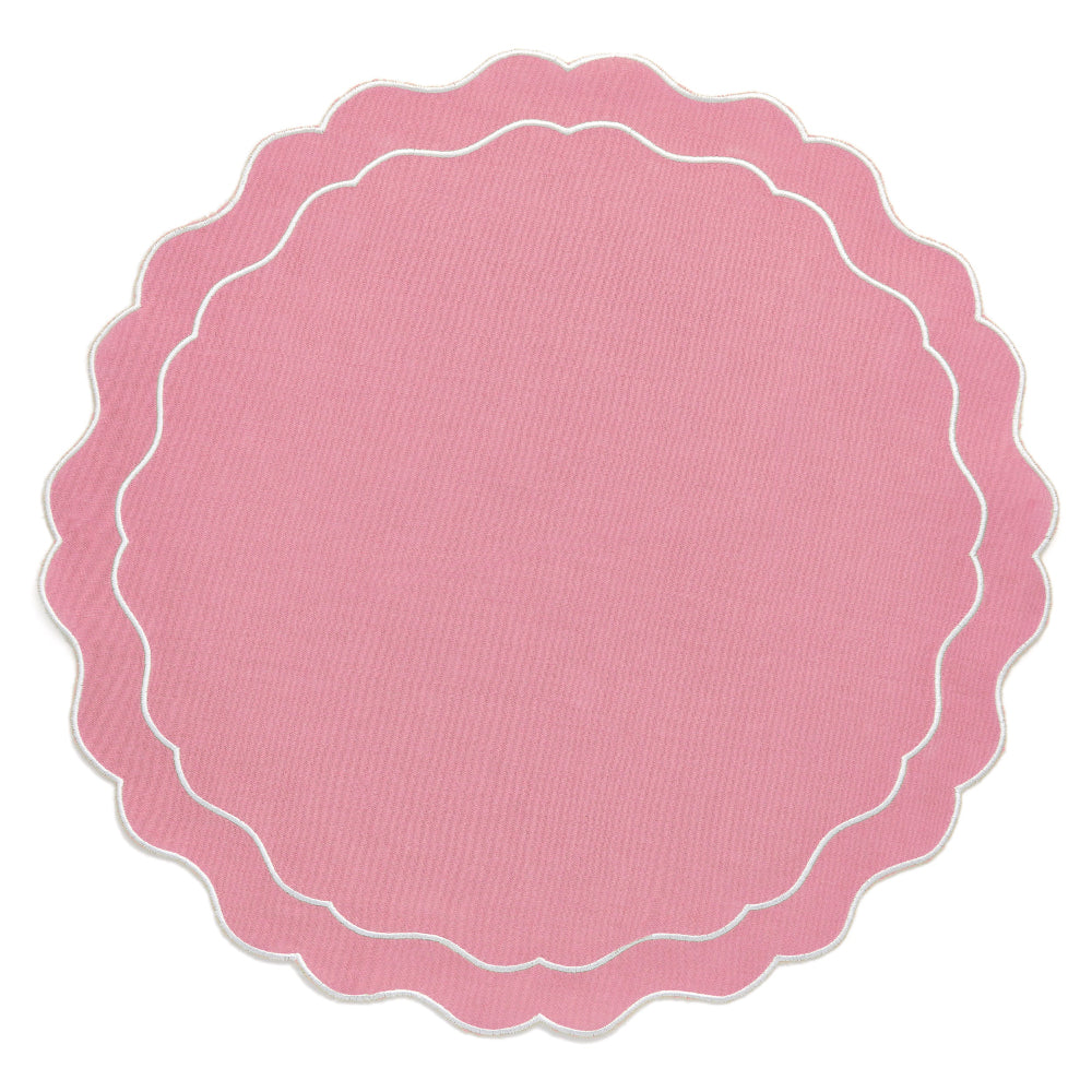 Pink scalloped edge dinner placemat on a white background