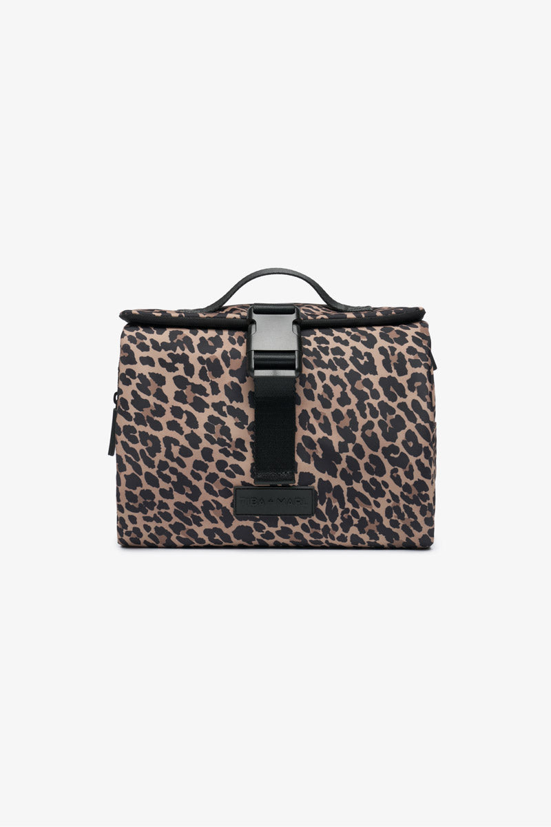 Leopard print roll up wash bag with black strap on a white background