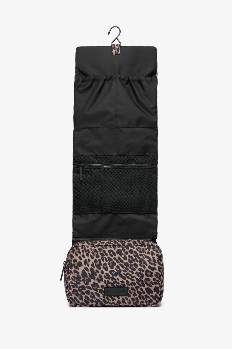 Black hanging travel organizer with leopard print base on a white background