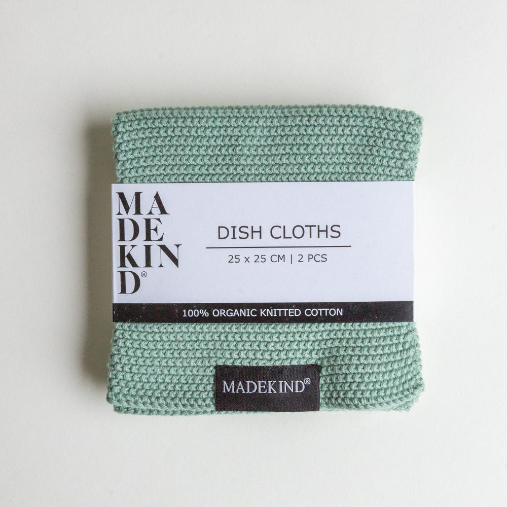 Pack of green dish cloths with 'MADEKIND' label on a light grey background