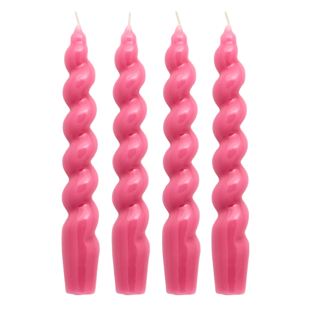Four pink twisted candles on a white background