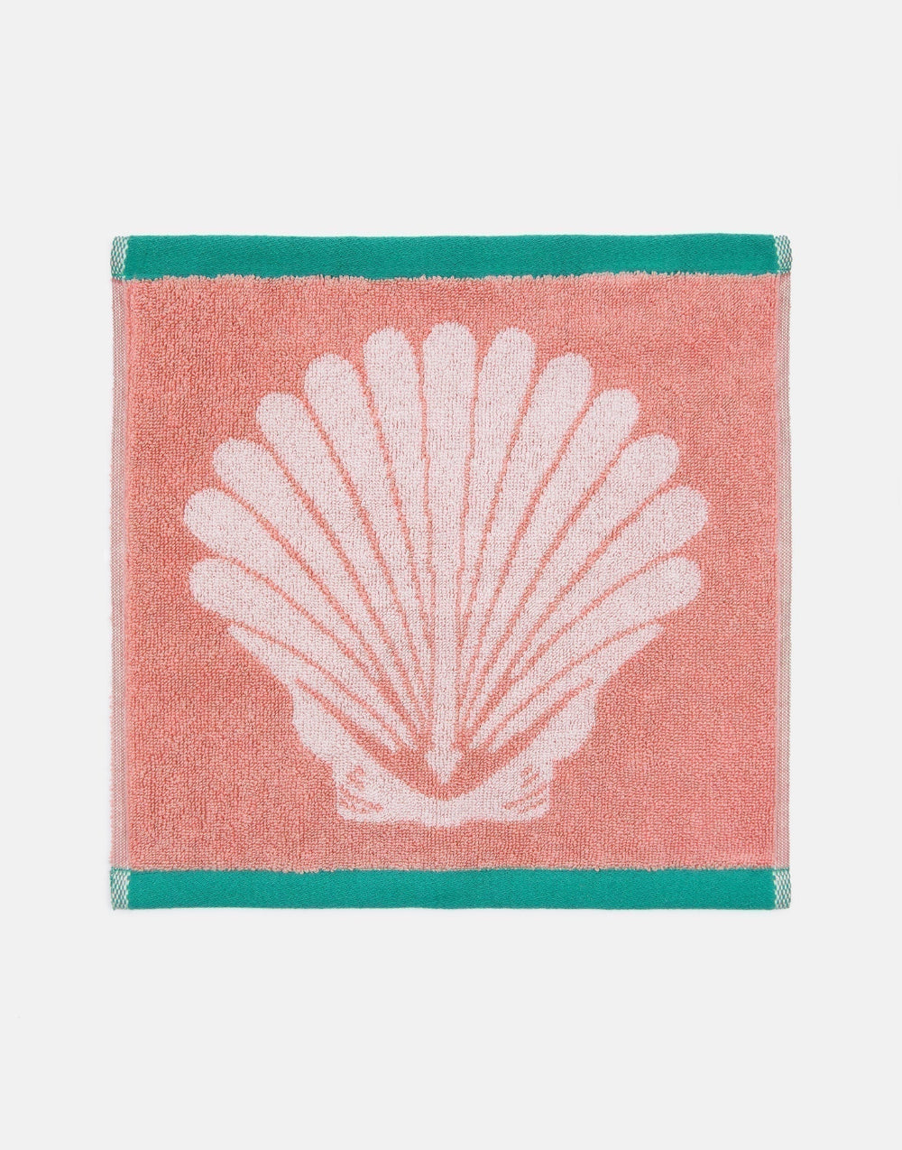 Pink towel with a white shell design on a white background