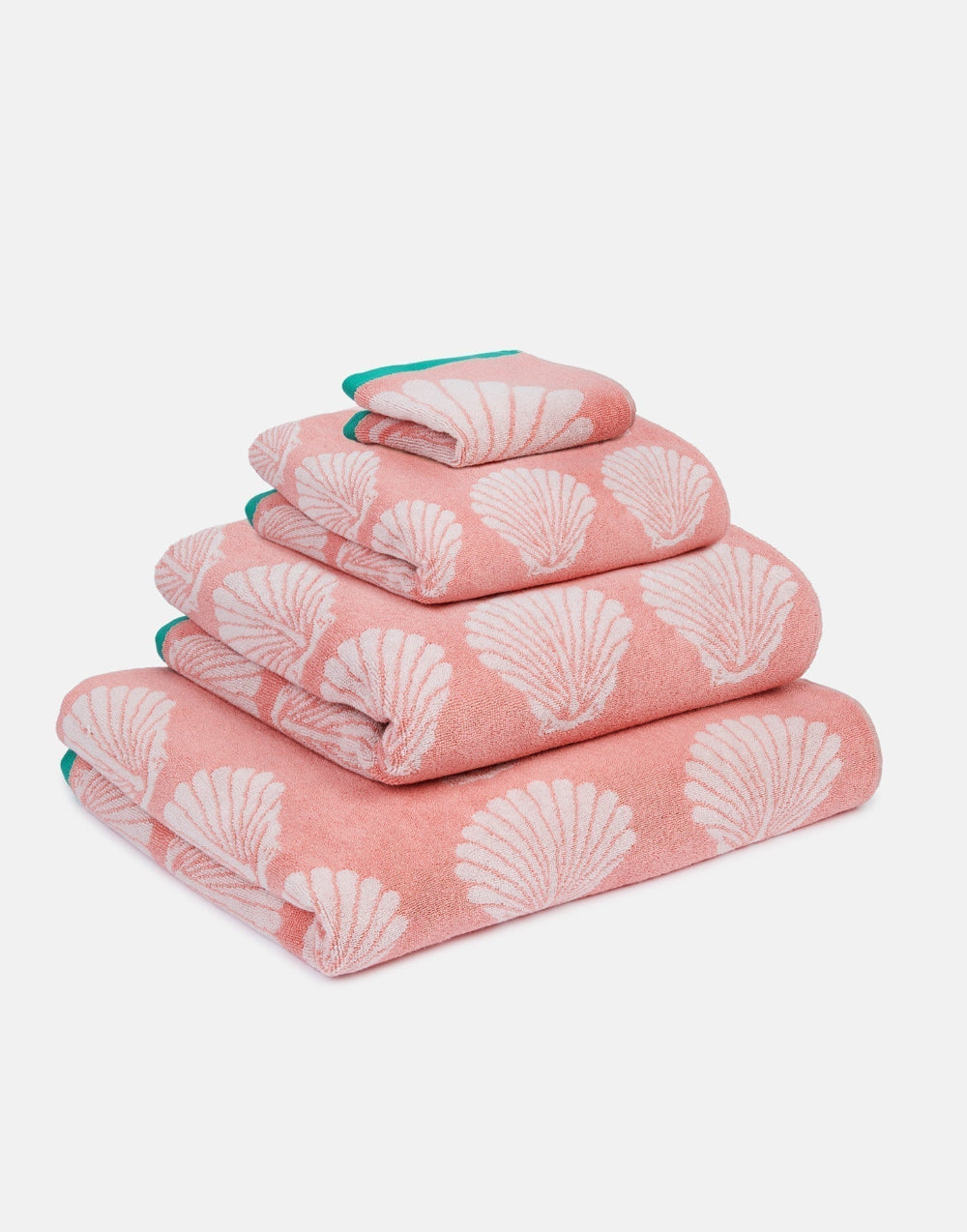 Set of pink towels with shell pattern on a white background