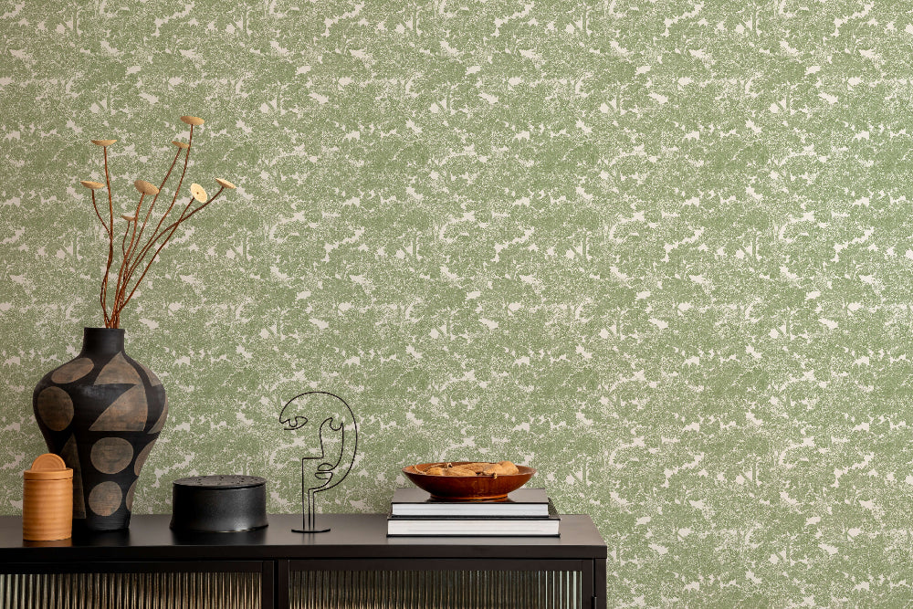 Decorative items on a table against the Sherwood Tree Wallpaper in green.
