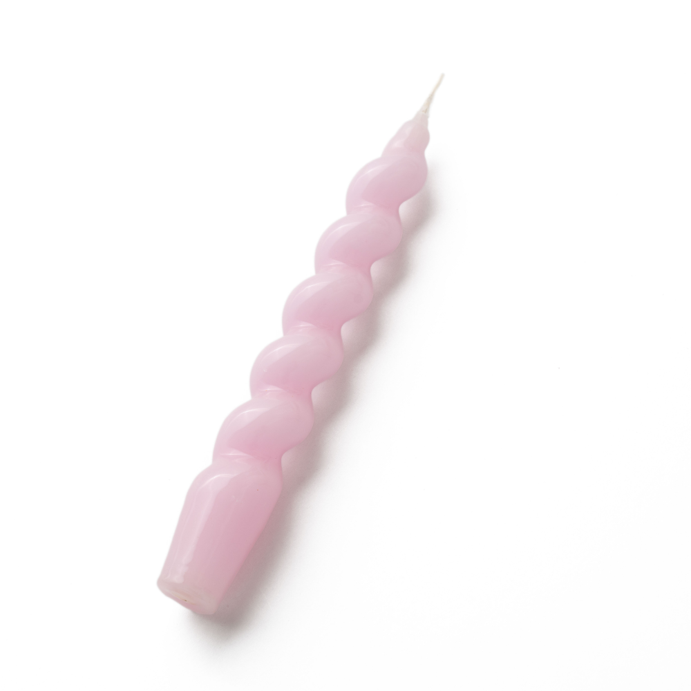 Pink spiral gloss textured candle on a white background