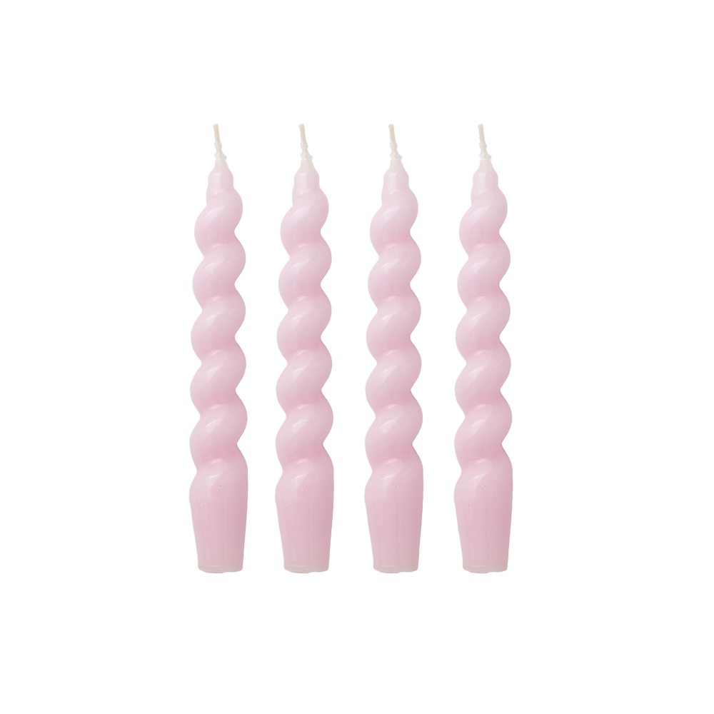 Four pink spiral candles on a white background