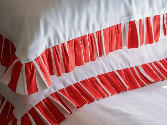 Red and white striped bedding on a bed