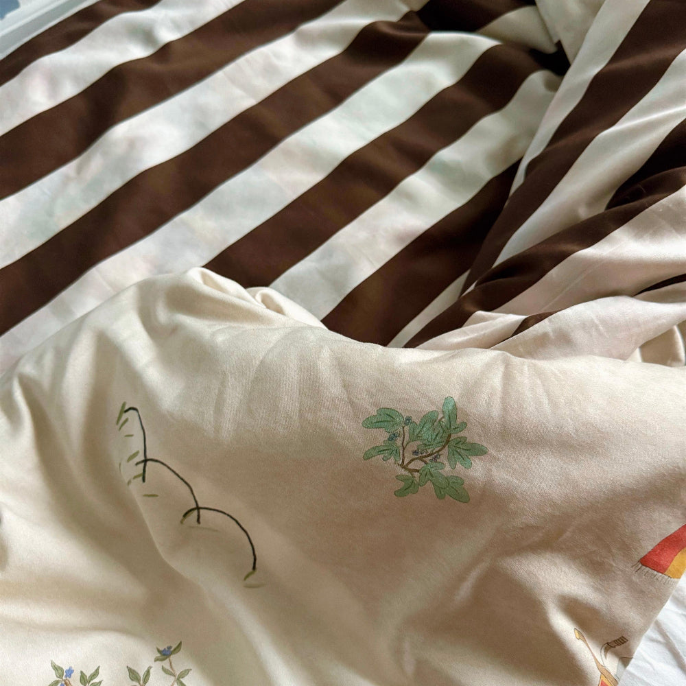 Close-up of a striped bedding with cartoon designs on a beige background